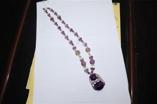 A Chinese amethyst and rock crystal pendant hung from a carved amethyst and rock crystal necklace, pendant 38mm.